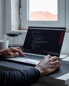 web developer's laptop with programming code