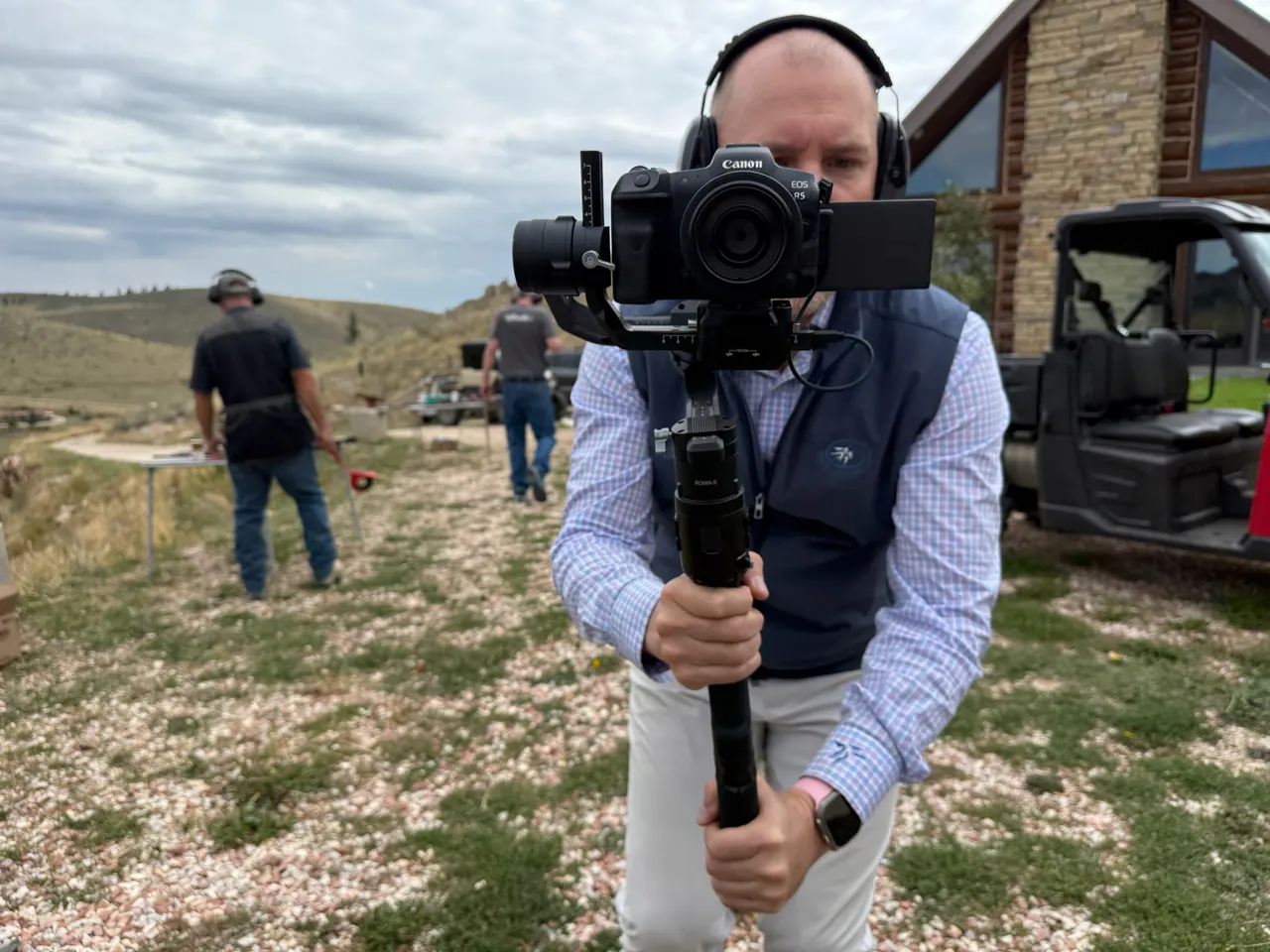 Camera operator holding a stabilized camera rig outdoors